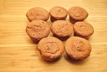 Homemade Muffins Cooling on a Wooden Cutting Board