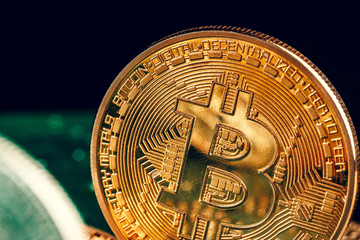 golden bitcoin and computer chip in background