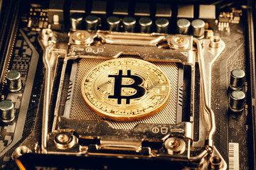 golden bitcoin and computer chip in background