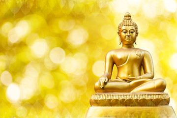 Beautiful of Golden Buddha statue on golden yellow bokeh background.