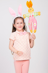 Easter concept - egg hunt seasonal holiday little girl looking for Easter eggs, playing, in studio with big tulip, isolated on white