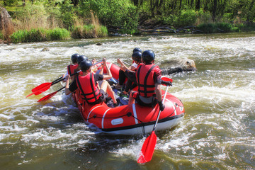  Rafting team , summer extreme water sport. Group of people in a rafting boat, beautiful adrenaline ride down the Pacuare River, Costa Rica.
