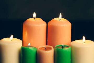 candles burning in darkness over black background. commemoration concept.