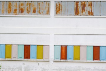  Blurred a row of colorful windows on old white wall of the building for background texture,retro style exterior 