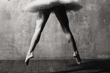 Ballerina in ballroom. Ballet dancer in studio. Black and white monochrome.