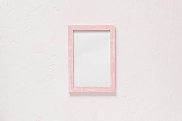 wooden photo frame on white wall baxkground. Minimal flat lay with copy space. Toned