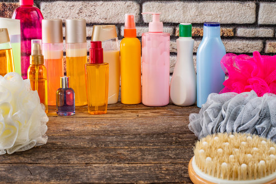 Many Kind Of Shampoo And Shower Gel Bottles And Sponge On The Table