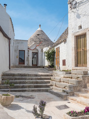 ALBEROBELLO, ITALY - April, 2019: Alberobello's famous Trulli, the characteristic cone-roofed...