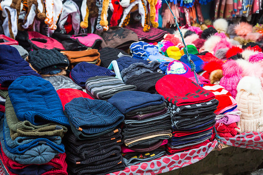 Selling colorful handmade winter woolen caps scarfs cloths at mall road,local street market of himachal pradesh - Image