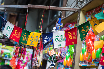 Colorful Tibetan buddhist prayer flags displayed in shop for sale along with other gift items, nepal - Image