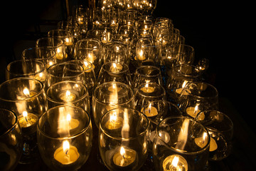 close up burning candel in glass for praying in temple Buddism