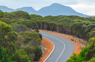 Natural scenery on the open road in Australian Outback.  Freedom and orange red road.