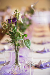 Elegant table setup in purple pastels for a restaurant wedding