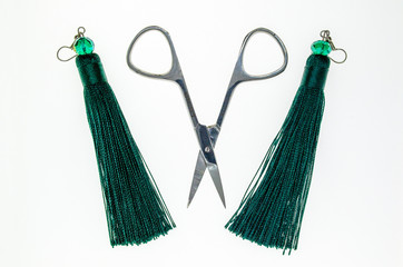 scissors and green jewelry in the form of brushes - 267795843