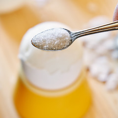 Putting a salt on the boiled chicken egg during breakfast