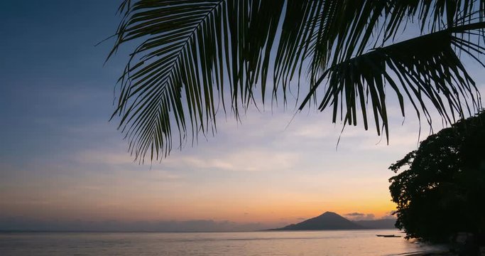 Time lapse sunrise colorful sky over active volcano Gunung Api view from Ai Island Banda Islands Maluku Indonesia famous for nutmeg plantations