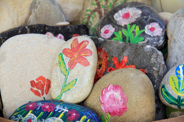 Handcraft artist paints on stone. Authentic pictures on natural stones for souvenirs and home decoration, greek domestic life