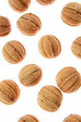 Fresh cakes walnuts pattern on a white background.