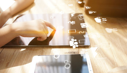 hand presses social media icons on screen digital tablet