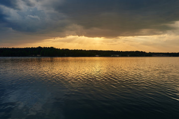 Clear lake at sunset. Beautiful summer landscape.