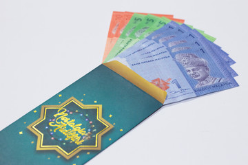 Fototapeta premium 'Duit Raya' is money given from adult to children during Eid al-Fitr celebration in Malaysia. This is a Malay tradition and regarded as alms to the children.
