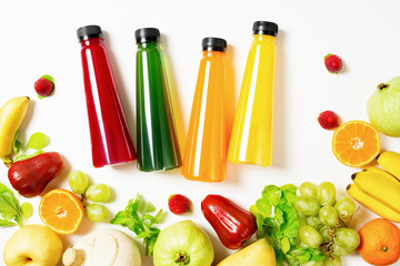 top view flat lay Colorful juice bottles with ingredients isolated on white background. Healthy lifestyle, vegetarian food concept. Detox