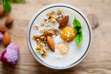 Yellow raspberries smoothie with coconut and almonds
