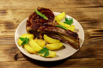 Roasted beef rib eye steak on bone with baked potatoes and herbs on wooden table