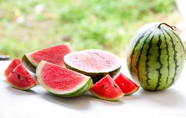Watermelon cut into pieces on a wooden cutting board placed on the table,Summer fruit that is juicy