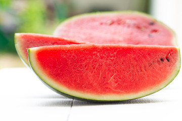 Watermelon cut into pieces on a wooden cutting board placed on the table,Summer fruit that is juicy