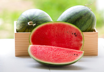 Watermelon cut into pieces on a wooden cutting board placed on the table,Summer fruit that is juicy