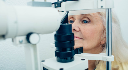 Senior woman having eyesight examination at doctor office
