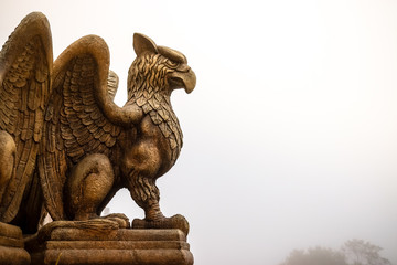 statue of Griffin or griffon a legendary creature with the body of a lion, the head and wings of an...