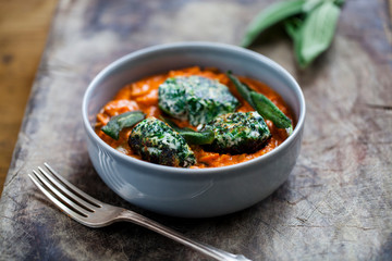 Spinach and ricotta dumplings in tomato and courgette sauce 