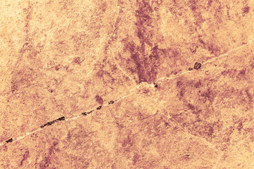 Vintage yellow background. Rough painted wall of aspen gold color. Imperfect plane of golden colored. Uneven old decorative toned backdrop of yellow tint. Texture of gold hue. Ornamental stony surface
