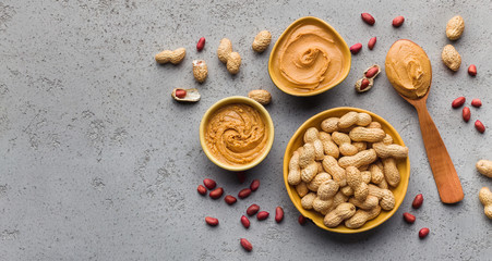Bowls with peanut butter and peanuts