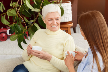 Obraz na płótnie Canvas Woman visiting senior mother and having coffee