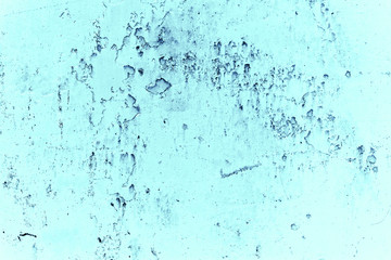 Vintage blue background. Rough painted wall of sapphire color. Imperfect plane of blue colored. Uneven old decorative toned backdrop of cyan tint. Texture of sapphirine hue. Ornamental stony surface.