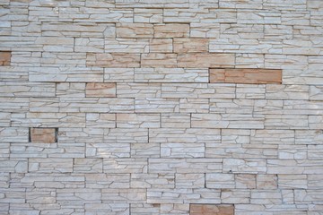 Vintage artificial stone masonry wall,in the shadow