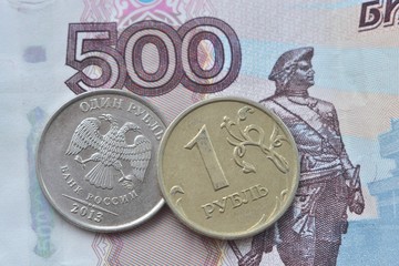 Russian ruble close-up on the background of 500-ruble banknote