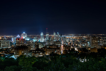 Montreal urban skyline in a summer night with tall skyscarapers and blue sky