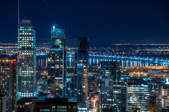 Montreal urban skyline in a summer night with roofs and river in the background - Powered by Adobe