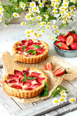 Sweet homemade strawberry pies with fresh mint leaves 