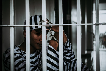 Hands of men desperate to catch the iron prison,prisoner concept,thailand people,Hope to be free.