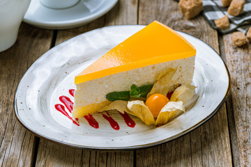 Cheesecake passion fruit on wooden background