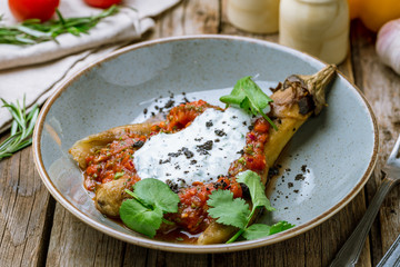 baked eggplant on plate on wooden background