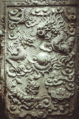 Fototapeta na wymiar detail of an old stone chinese sculpture door