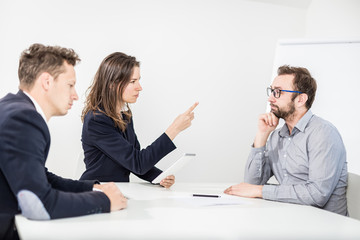 Angry female boss on a business meeting with her colleagues.