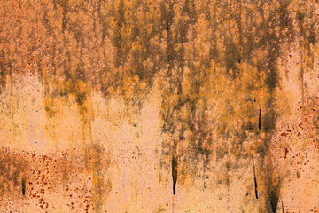 Rusty yellow-red textured metal surface. The texture of the metal sheet is prone to oxidation and...
