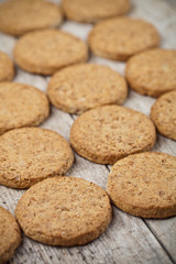 Fresh baked oat cookies closeup on rustic wooden table background.